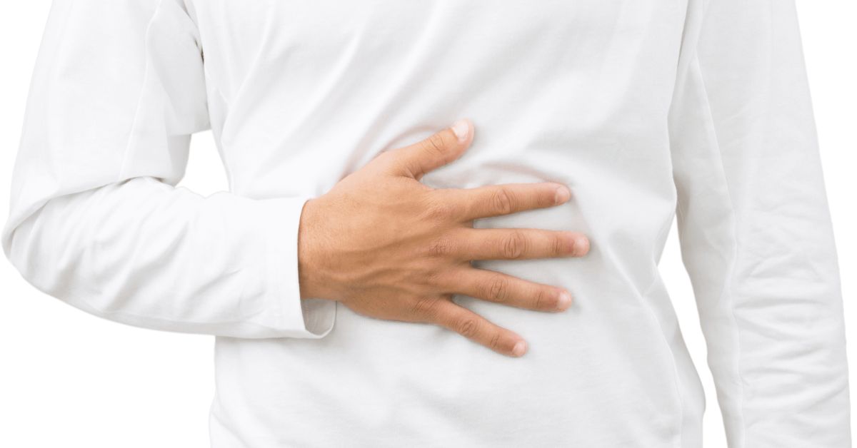 Man wearing white long sleeve shirt with his hand placed on his stomach indicating his Indigestion has been resolved. Words 4 Things that help Indigestion