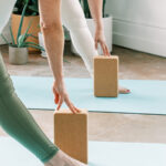 Self Care Motion Fitness Depicted buy 2 women having hands on Yoga blocks