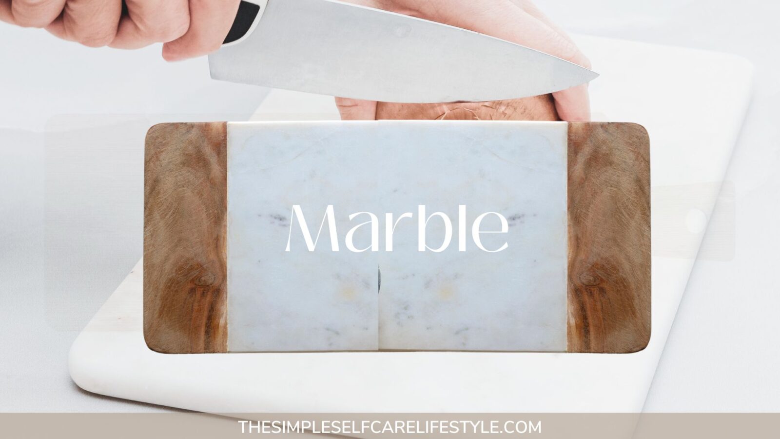 Hands in background holding a knife and cutting into an onion on a Non-toxic Cutting Board made from Marble. Forefront the word Marble.