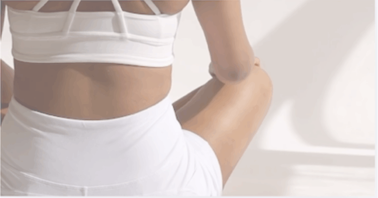 Back of a woman in white exercise clothing to represent 2 Simple Exercises for Spine Mobility